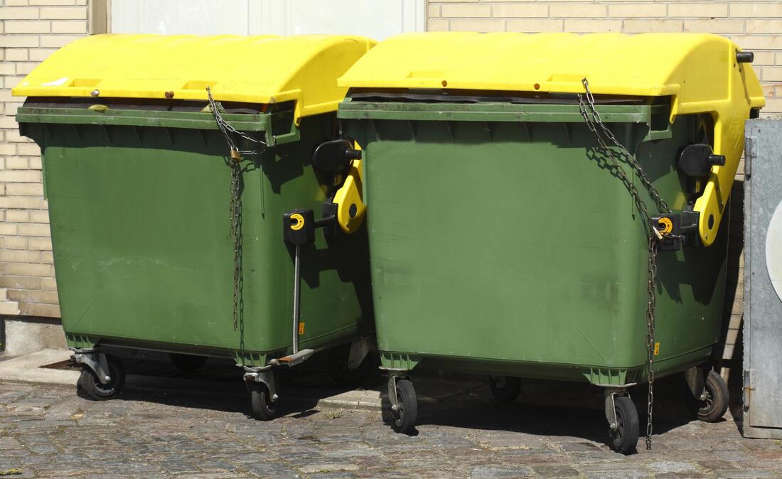 two green dumpster bins